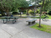 : Stan Clarke Park features a covered space with accessible picnic tables and paved pathways.