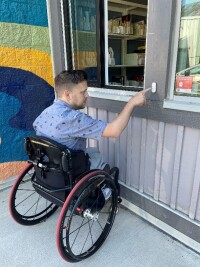 Wheelchair accessible book drop and service window at the rear of the library building