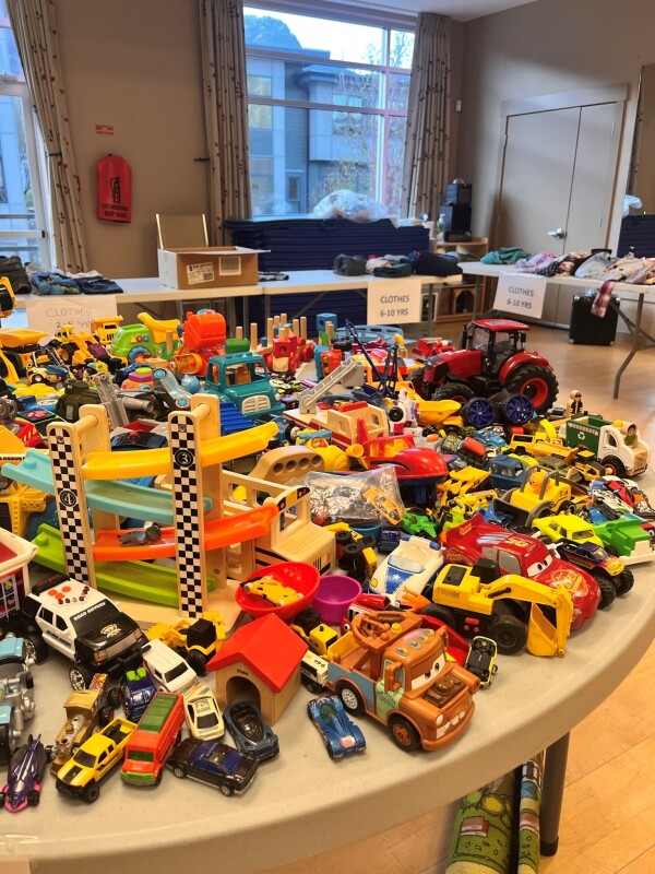 Table covered in toys at the kids clothing and toy swap.